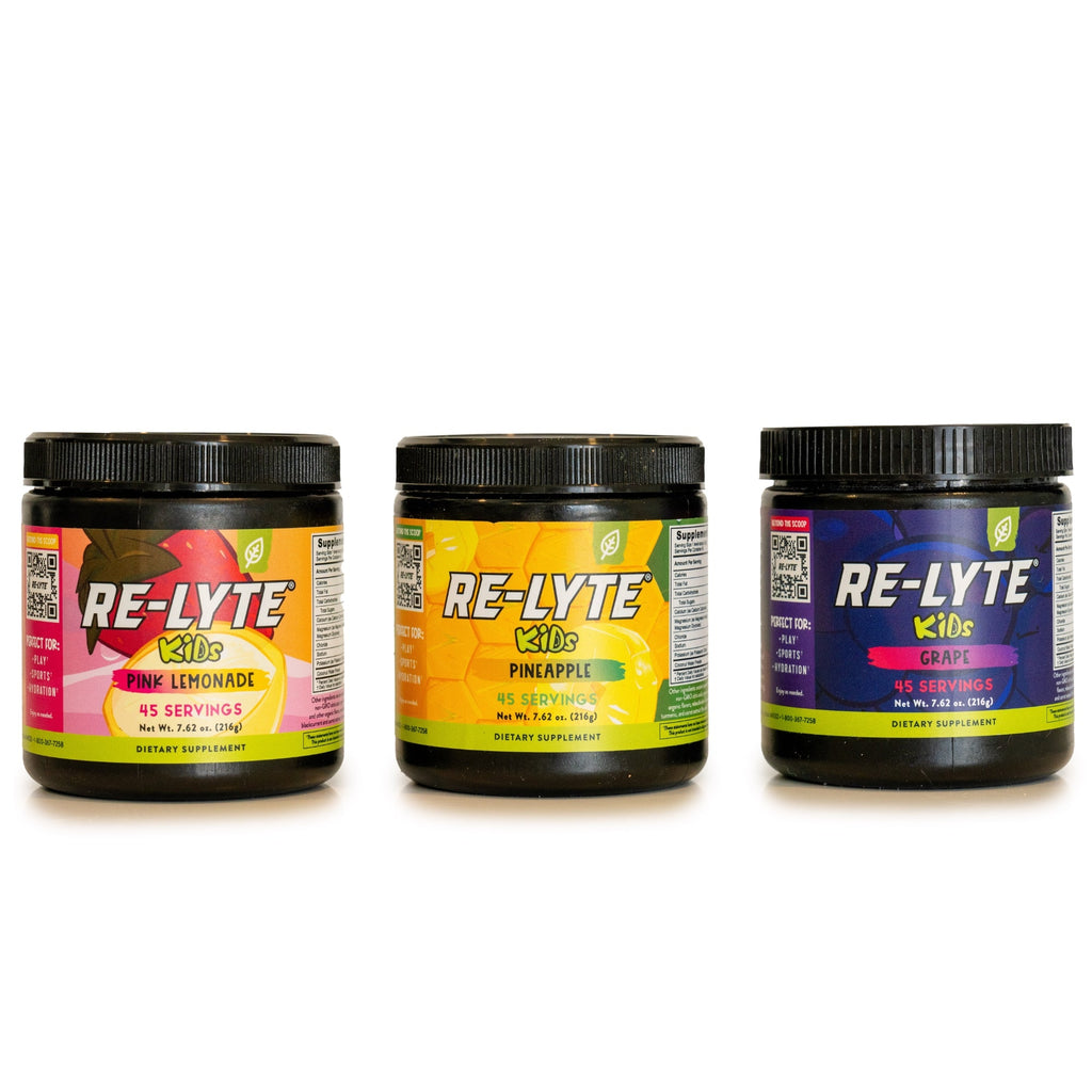 Three black tubs of Re-Lyte Kids Hydration Electrolyte Powder in Pink Lemonade, Pineapple, and Grape flavors. 

