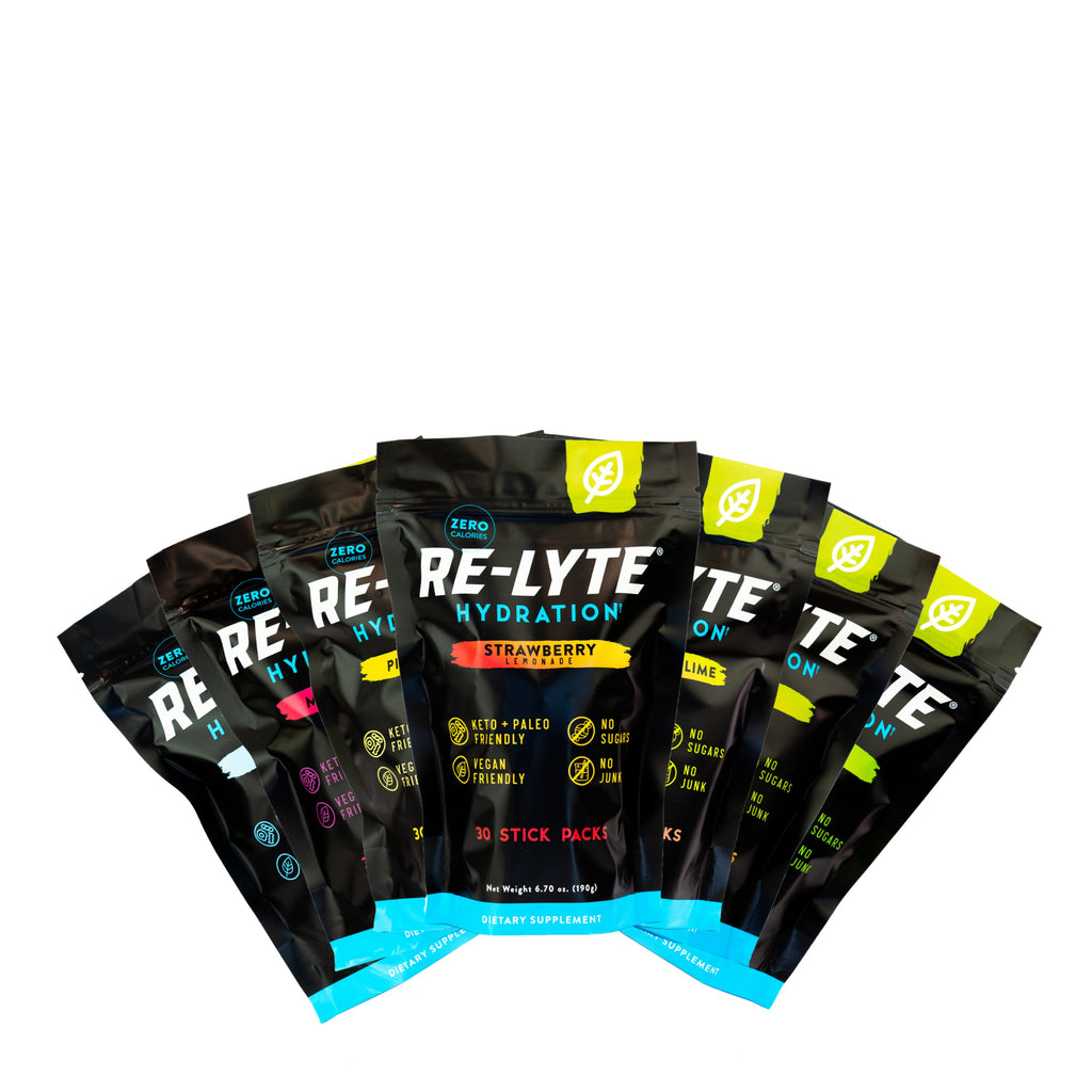 Seven flavor options of Re-Lyte Hydration 30 count stick packs electrolyte powder on white background. Flavors including: Piña Colada, Mixed Berry, Watermelon Lime, Mango, Unflavored, Lemon Lime and Strawberry Lemonade.